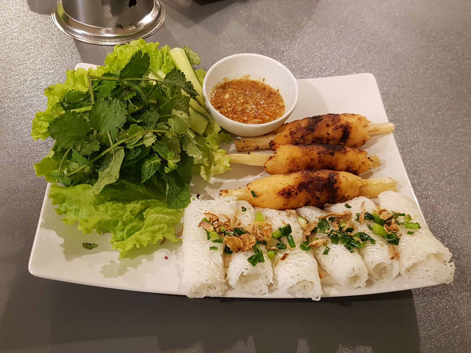 Char grilled prawn mince on a sugar cane stick.